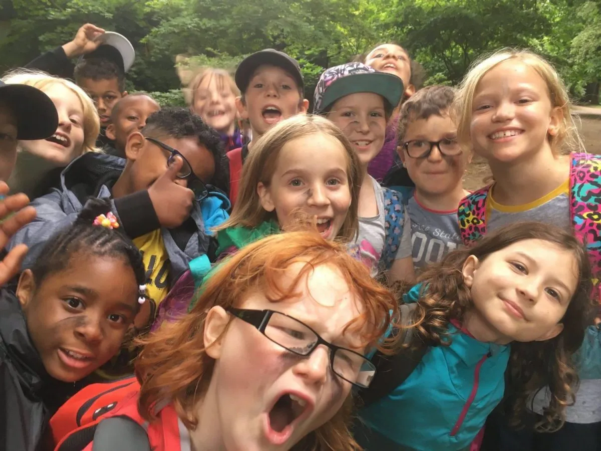 Children enjoying a Wild Learning holiday club in the woods